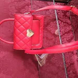 Small Red Pleather purse with shiney gold heart magnetic closure.